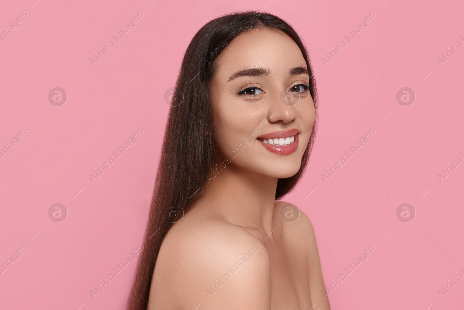 Photo of Portrait of beautiful young woman with elegant makeup on pink background