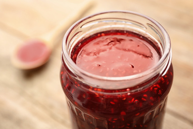 Homemade delicious raspberry jam on table, closeup