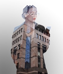 Double exposure of businesswoman using phone and office buildings