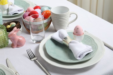 Photo of Easter celebration. Festive table setting with painted eggs.