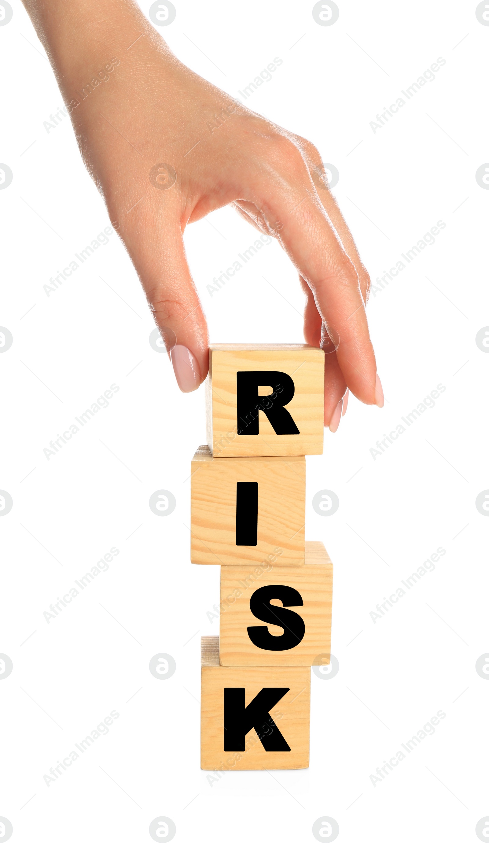 Photo of Woman stacking wooden cubes with word Risk on white background, closeup