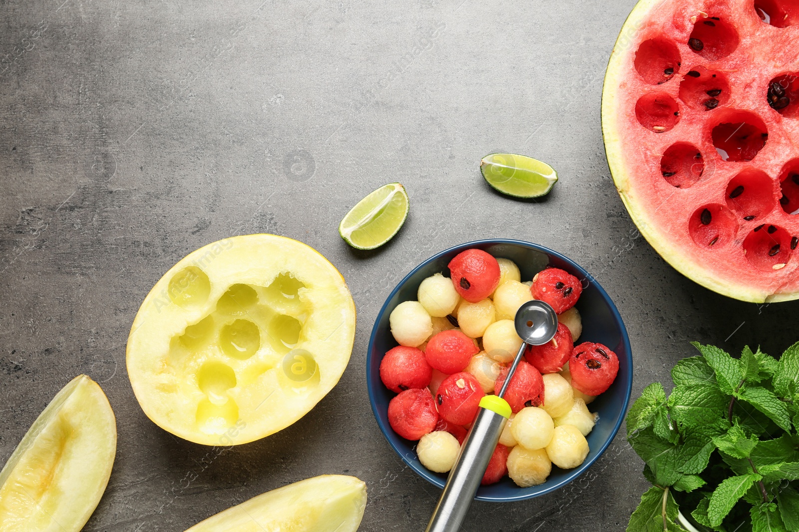 Photo of Flat lay composition with melon and watermelon balls on grey background