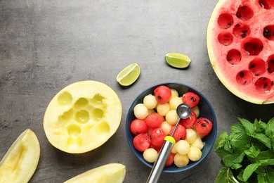 Flat lay composition with melon and watermelon balls on grey background