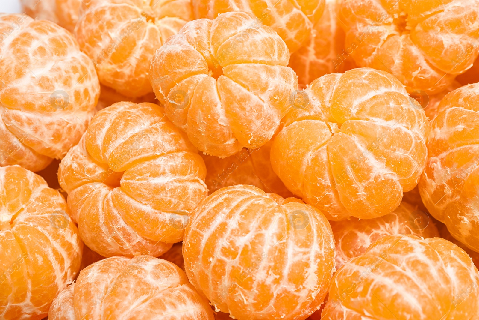 Photo of Peeled fresh ripe tangerines as background, closeup