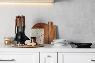 Photo of Set of different utensils and dishes on countertop in kitchen