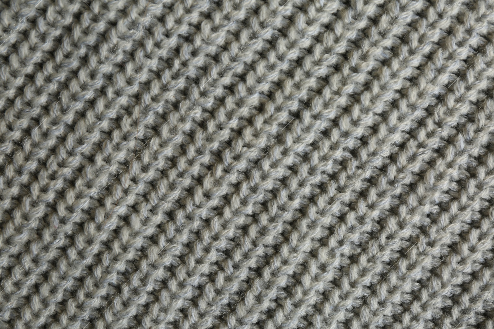 Photo of Beautiful grey knitted fabric as background, top view