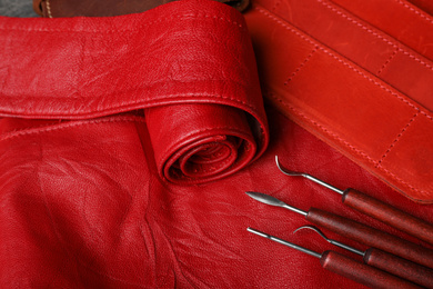 Photo of Set of craftsman tools on leather surface, closeup view