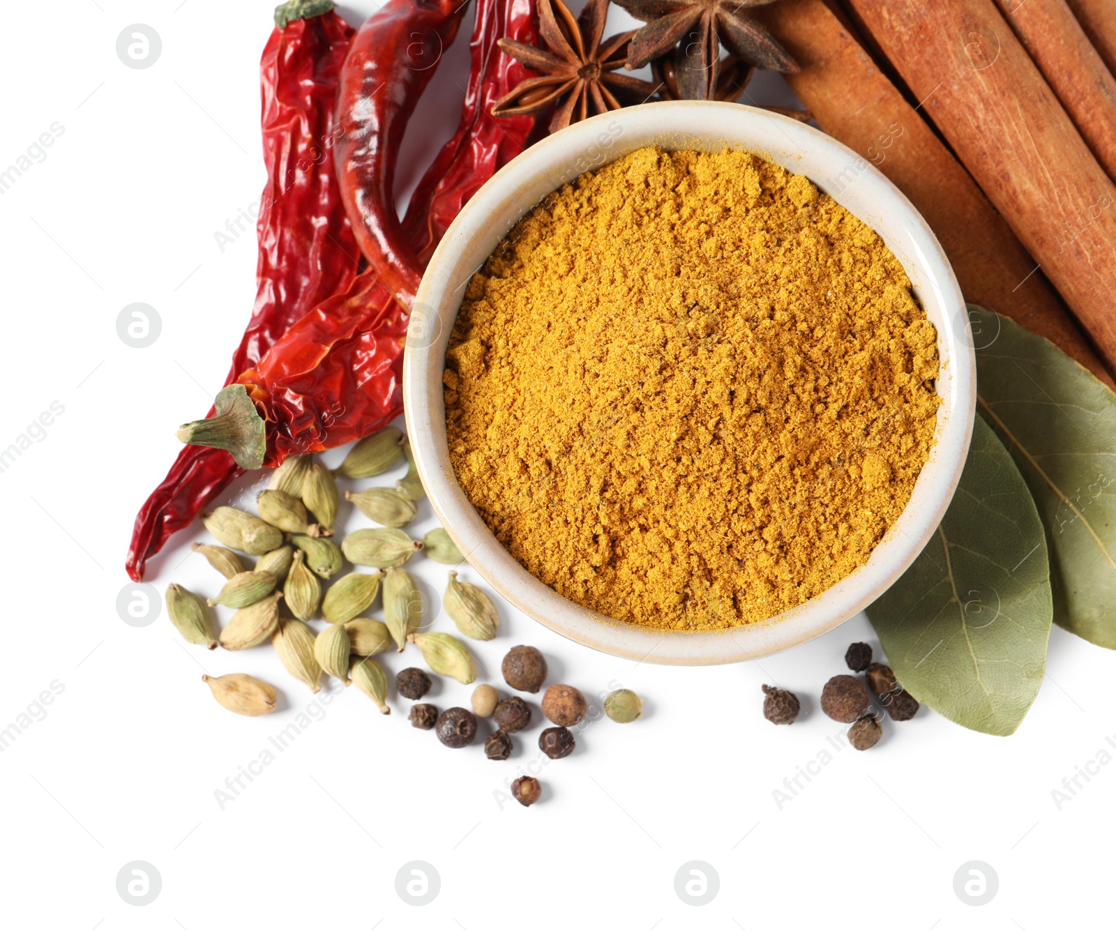 Photo of Curry powder in bowl and other spices isolated on white, top view