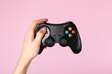 Photo of Woman with game controller on pink background, closeup