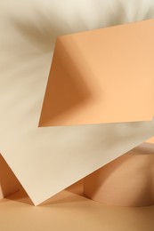 Photo of Presentation of product. Podium and paper on orange background