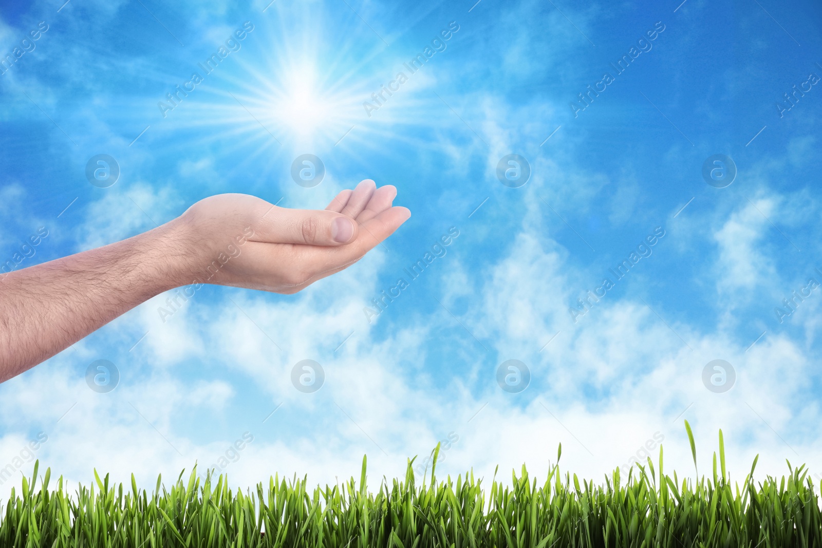 Image of Bright light in hand, closeup. Solar energy concept