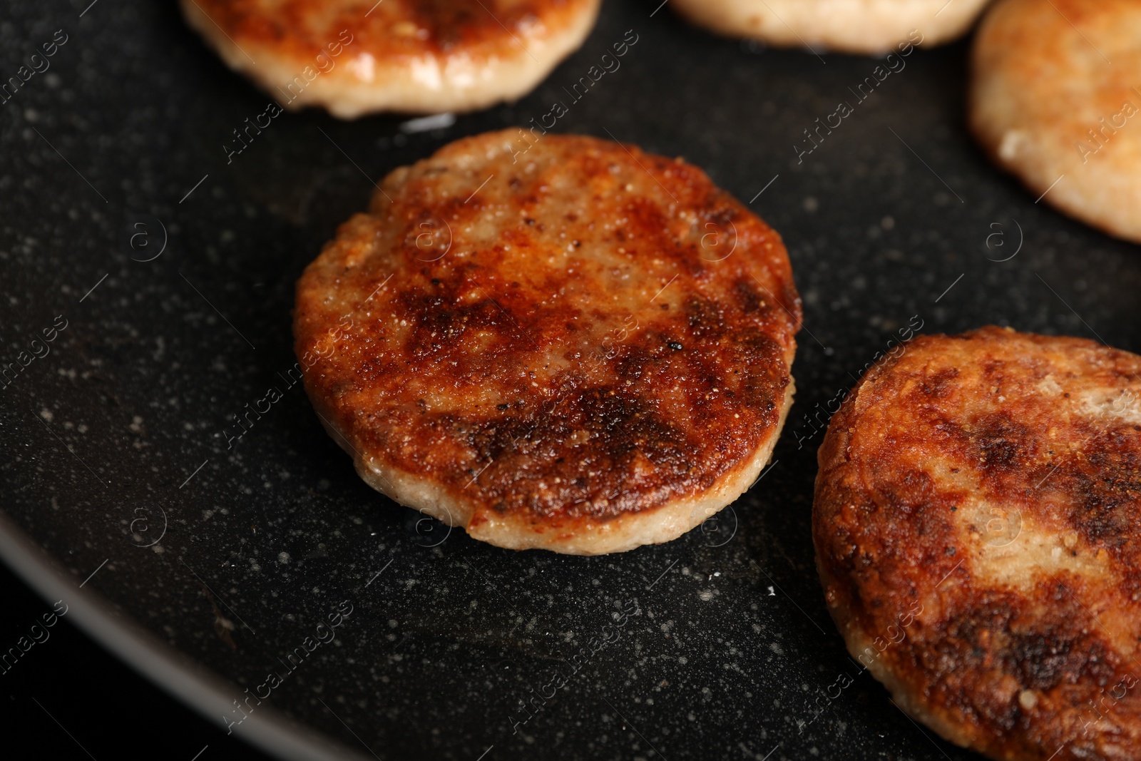 Photo of Cooking vegan cutlets in frying pan, closeup