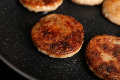 Cooking vegan cutlets in frying pan, closeup