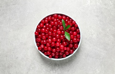 Photo of Tasty ripe cranberries on light grey table, top view