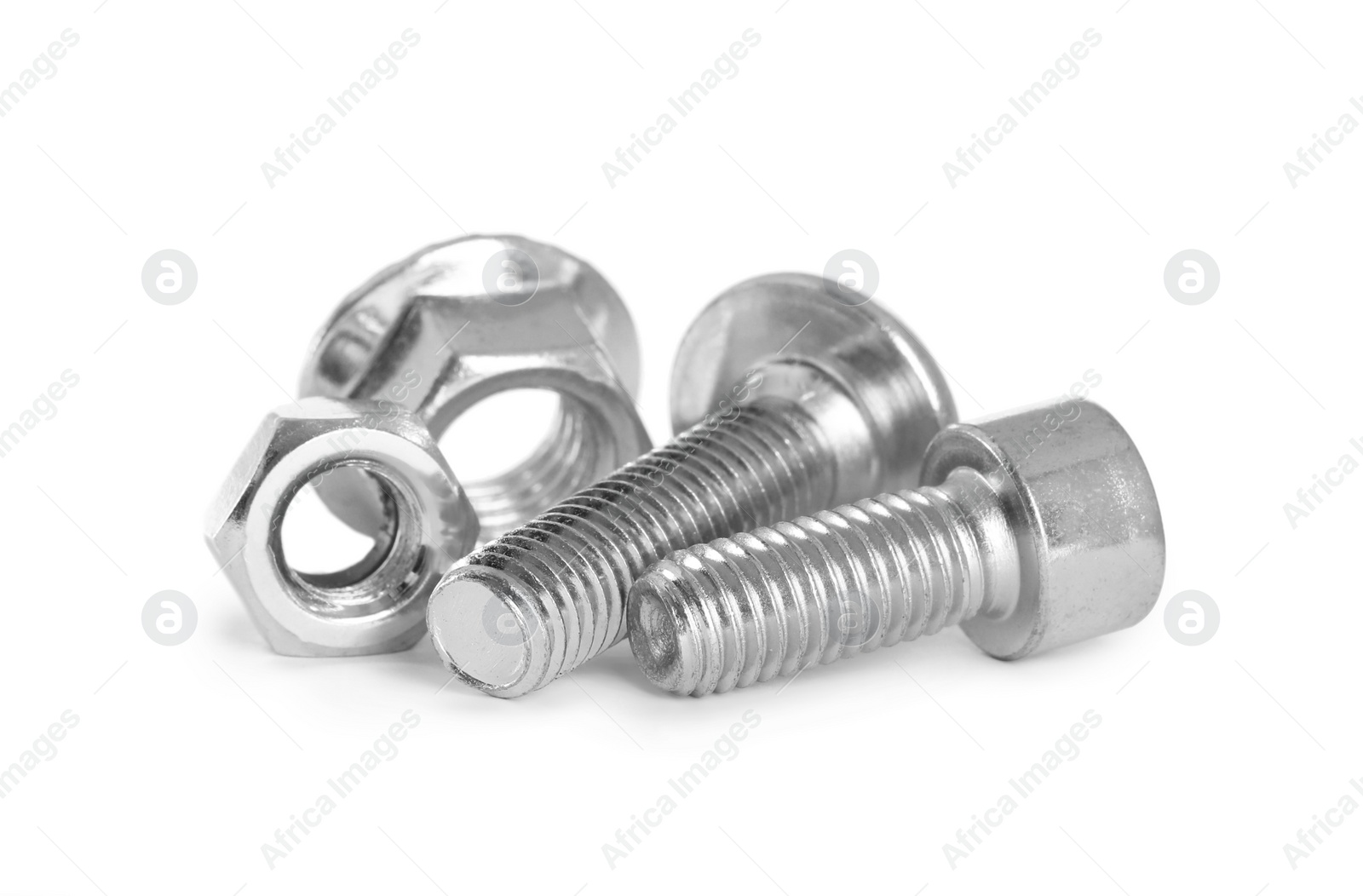 Photo of Different metal bolts and nuts on white background