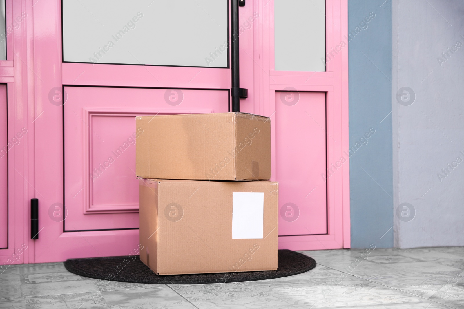 Photo of Delivered parcels on door mat near entrance