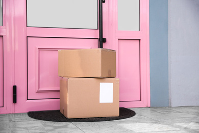 Photo of Delivered parcels on door mat near entrance