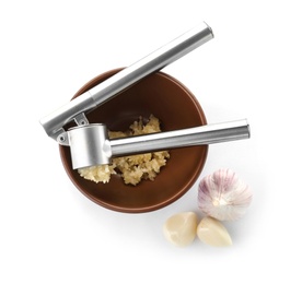 Photo of Garlic press and bowl with crushed cloves on white background