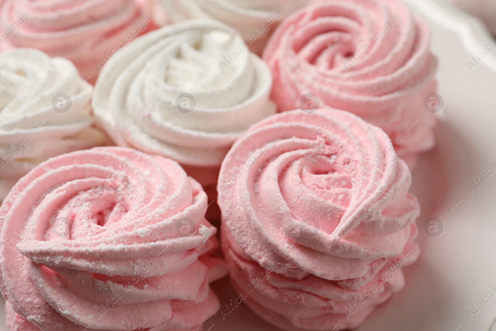 Photo of Delicious white and pink marshmallows on plate, closeup