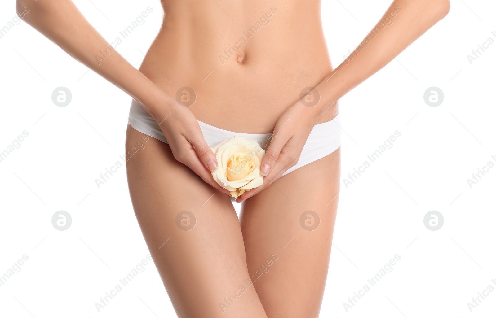 Photo of Woman with flower showing smooth skin after bikini epilation on white background, closeup. Body care concept