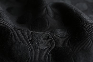 Photo of Textured black fabric as background, closeup view