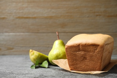 Tasty bread and pears on grey table. Homemade cake