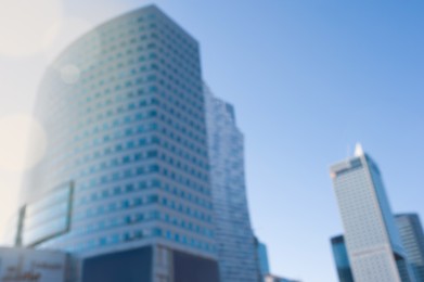 Blurred view of modern buildings on sunny day