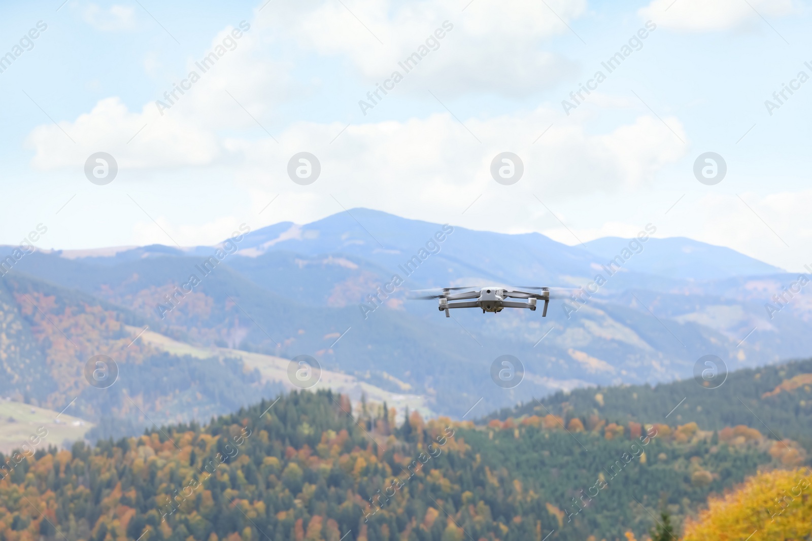 Photo of Modern drone flying in mountains on autumn day