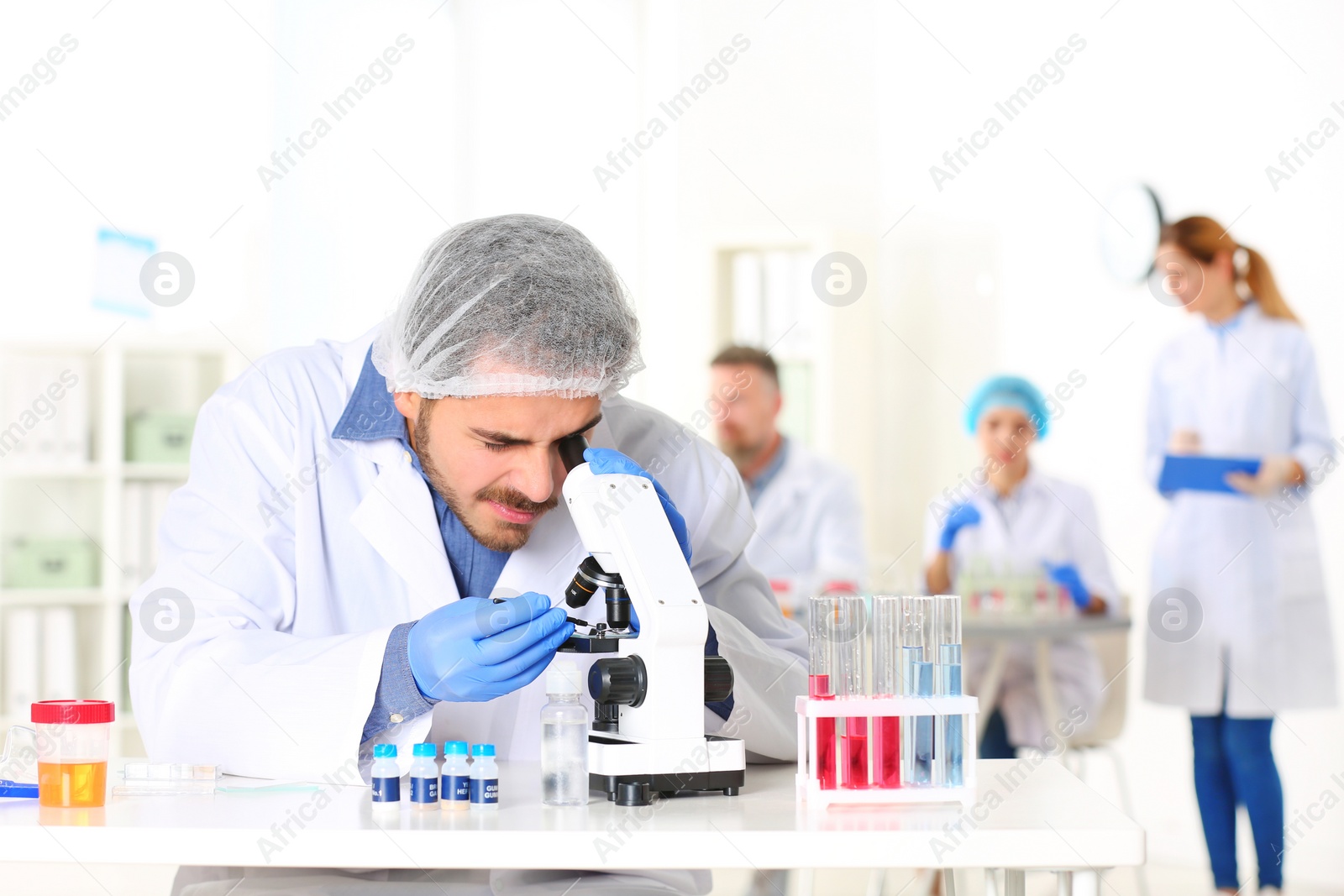 Photo of Male scientist working at table in laboratory, space for text. Research and analysis