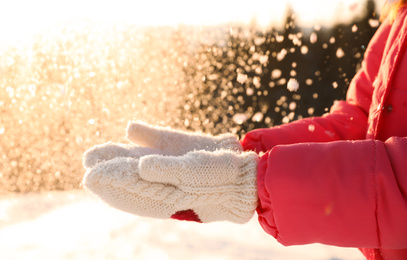 Young woman having fun outdoors on snowy winter day, closeup