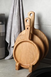 Photo of Wooden cutting boards on light grey countertop in kitchen