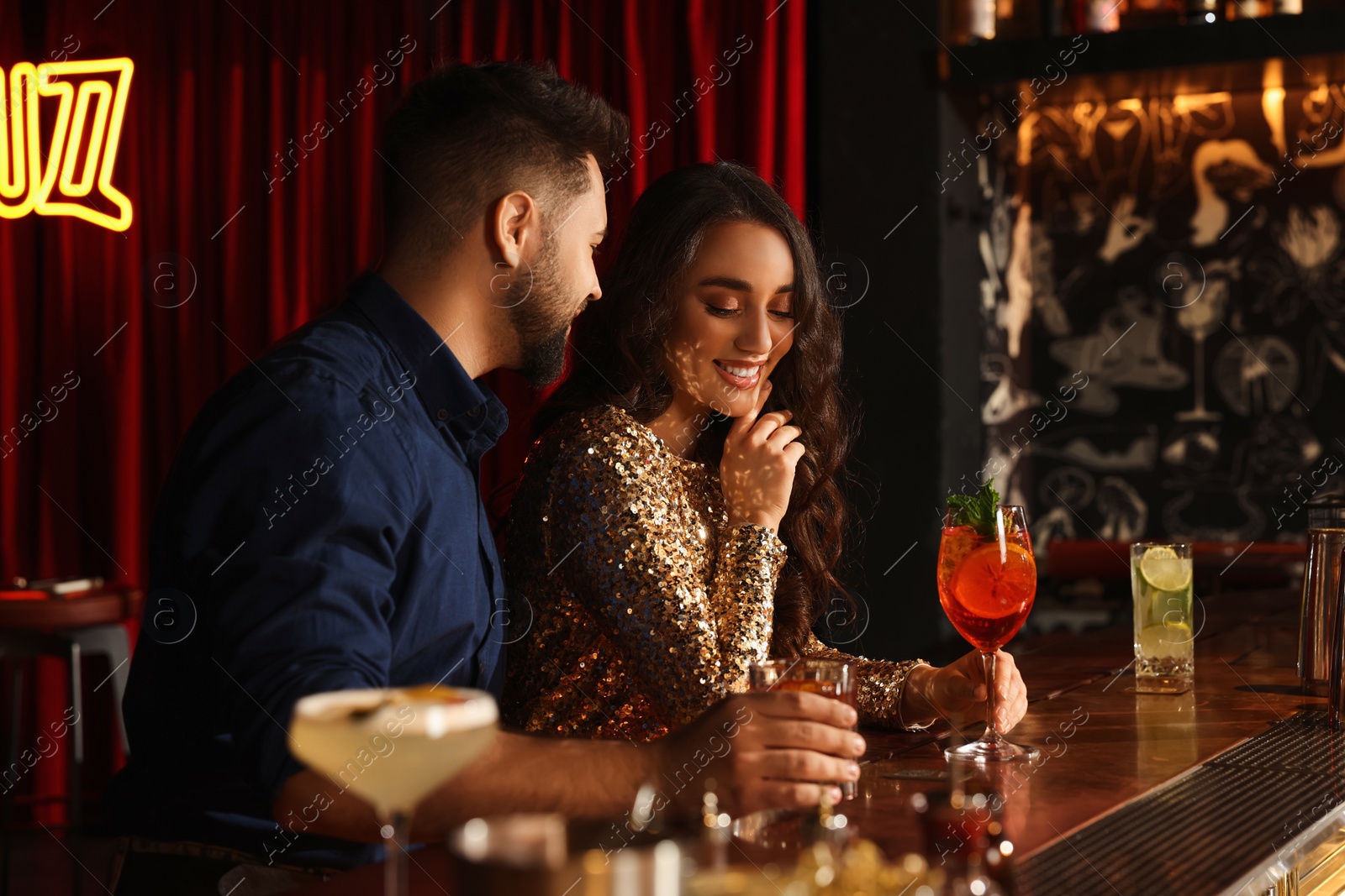 Photo of Lovely couple with fresh cocktails at bar counter