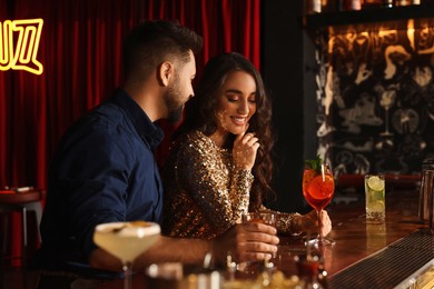 Photo of Lovely couple with fresh cocktails at bar counter