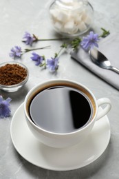 Photo of Cup of delicious chicory drink on light grey marble table