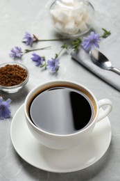 Cup of delicious chicory drink on light grey marble table