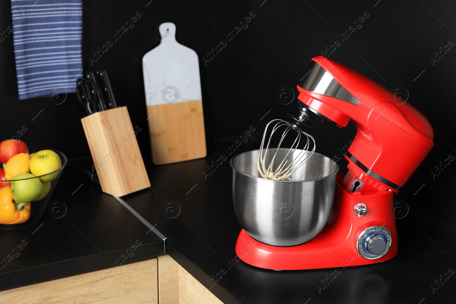 Photo of Modern stand mixer on countertop in kitchen. Home appliance