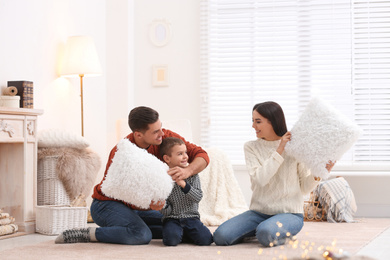 Photo of Happy family having pillow fight at home. Winter vacation