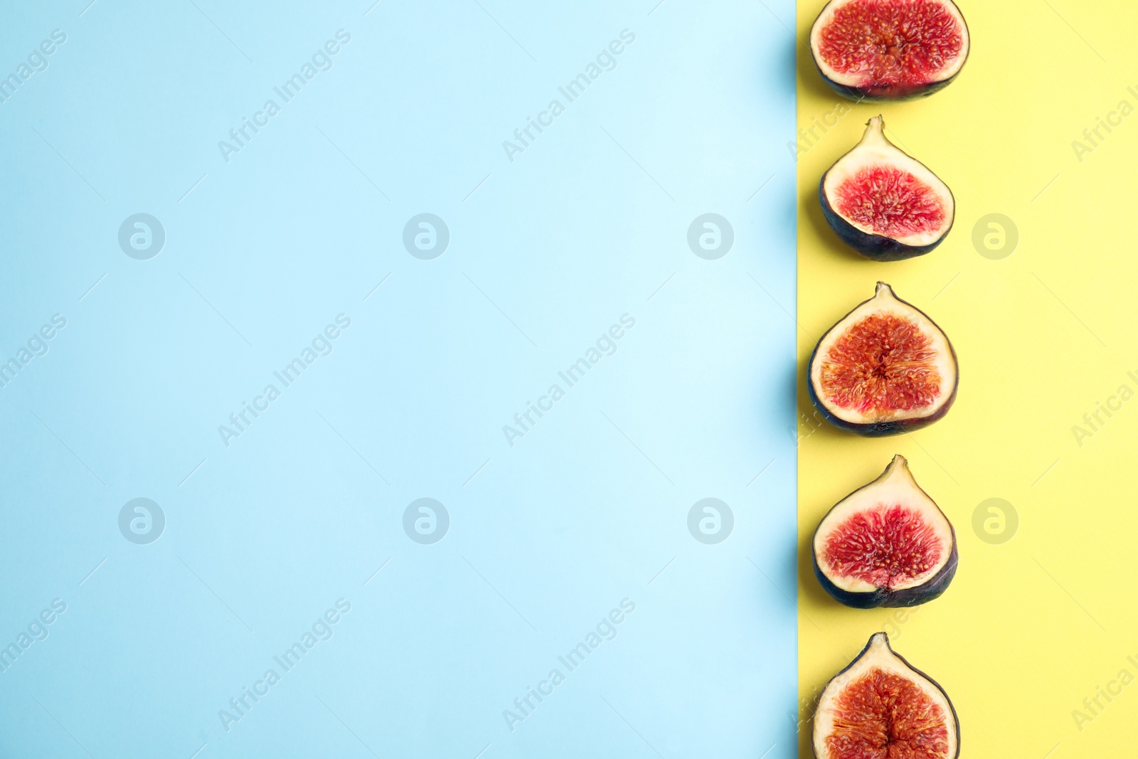 Photo of Delicious ripe figs on color background, flat lay. Space for text