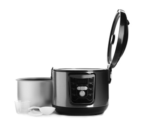 Disassembled electric multi cooker with accessories on white background