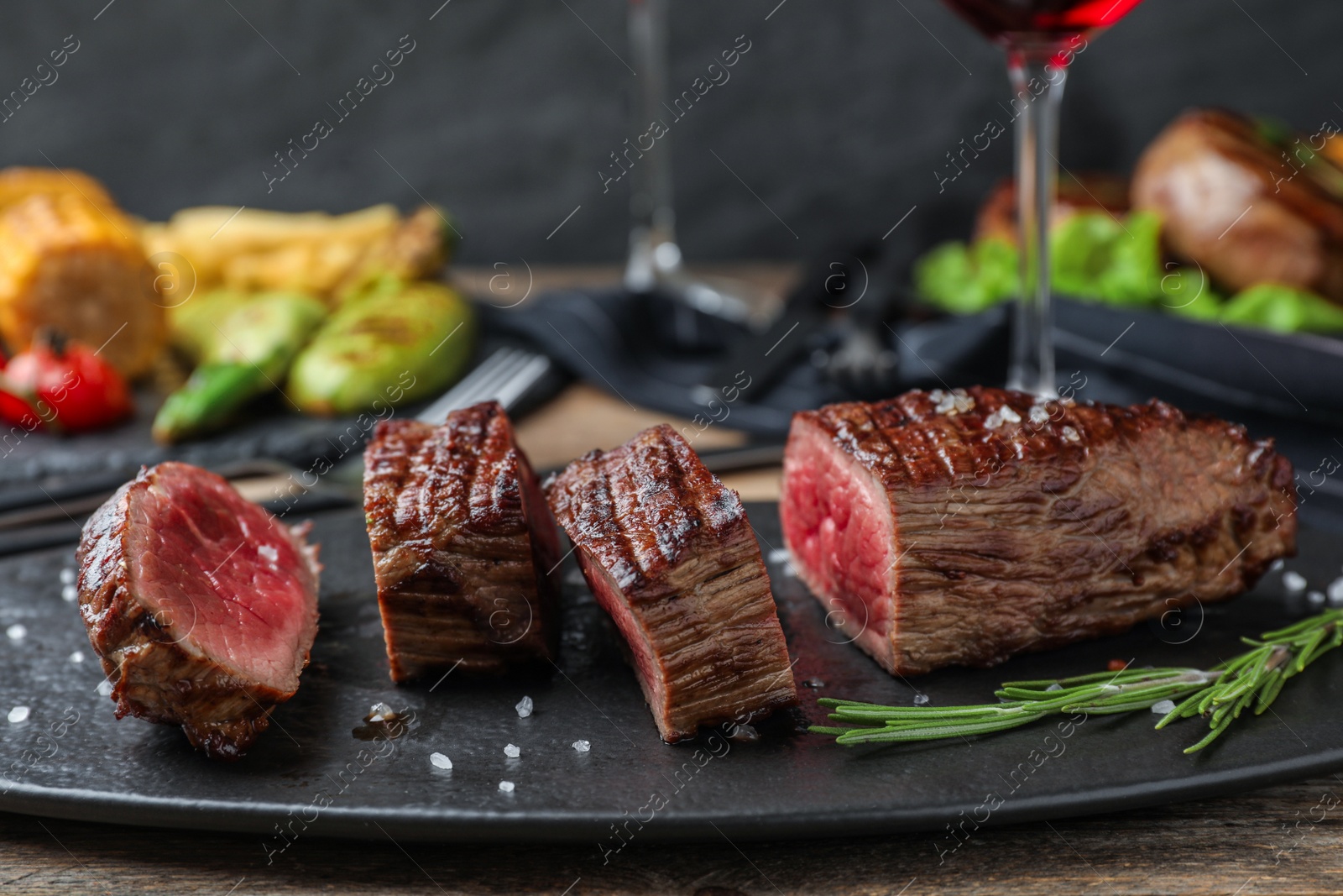 Photo of Delicious sliced beef steak served on table, closeup