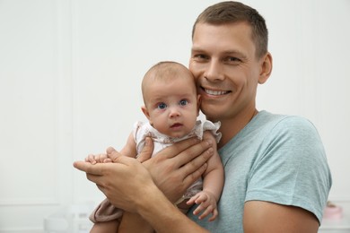 Happy father with his little baby at home