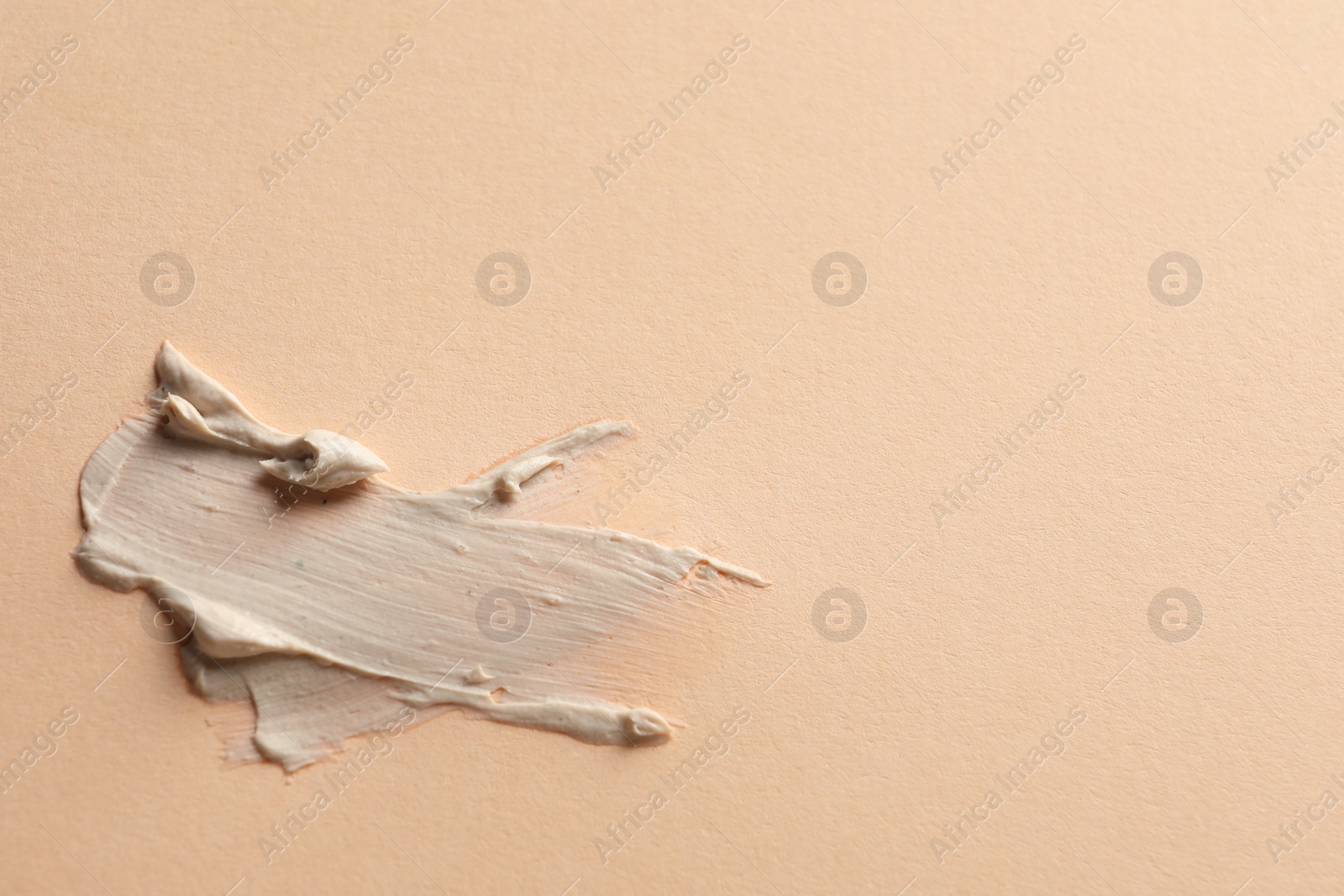 Photo of Sample of face mask on beige background, top view. Space for text