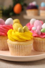 Photo of Tasty decorated Easter cupcakes on table, closeup