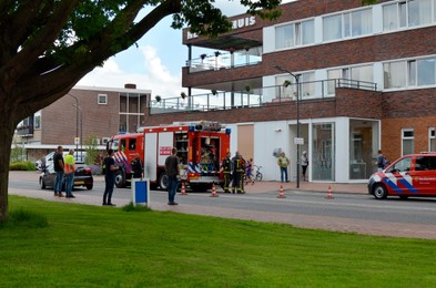 Photo of Oude Pekela, Netherlands - June 14, 2022: Modern red fire truck near building on city street