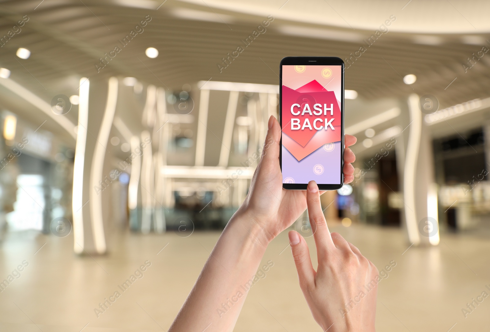 Image of Woman using smartphone with word Cashback and shopping cart icon indoors, closeup. Space for text