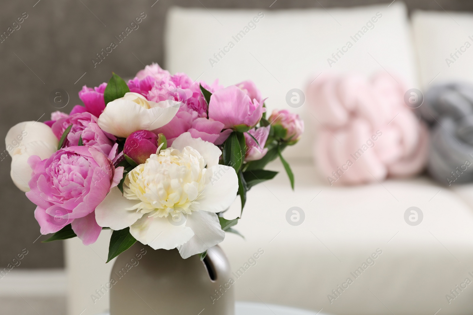 Photo of Vase with bouquet of beautiful peonies in room, space for text