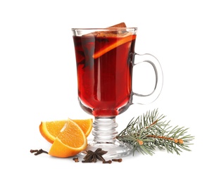 Photo of Glass cup of mulled wine with fir branch and orange isolated on white