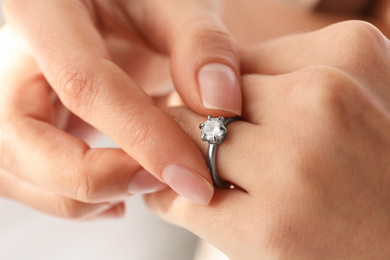 Young woman wearing beautiful engagement ring, closeup