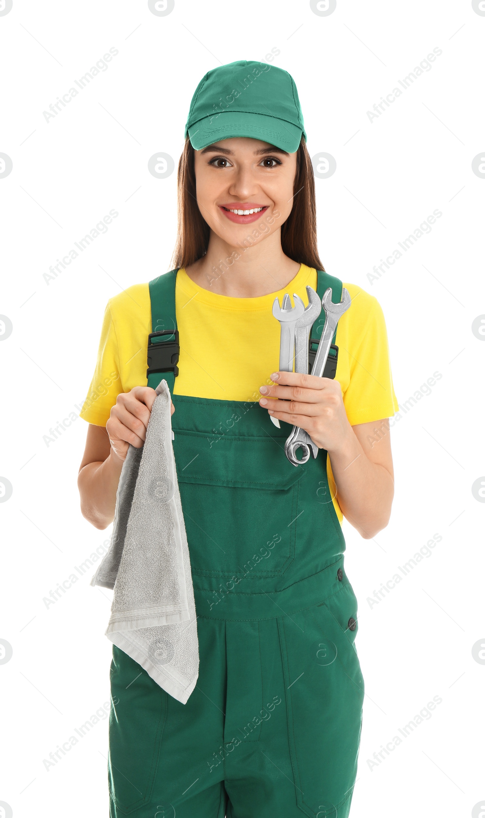 Photo of Portrait of professional auto mechanic with wrenches and rag on white background