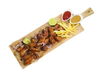 Photo of Wooden board with tasty roasted chicken wings, french fries and sauces isolated on white, top view